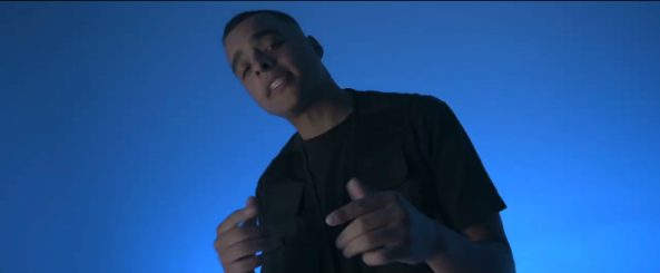 Still from the You video: a figure in a room washed in blue light